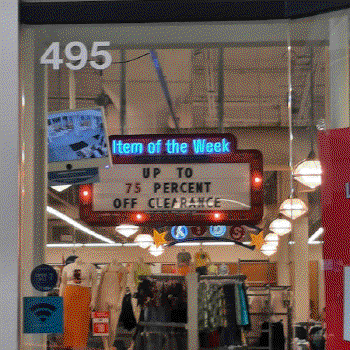 A sign with a red outline with lights, and the text on top reading Item of the Week