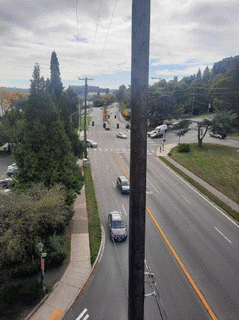 A picture of the street taken on a bridge above the road.